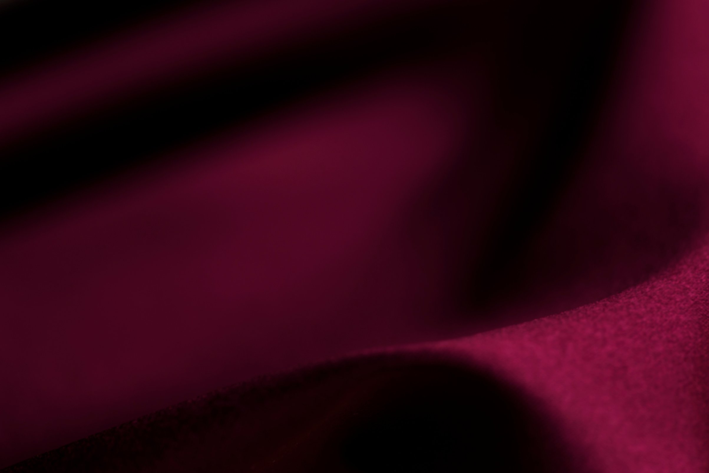 Burgundy satin background. Blurred Background